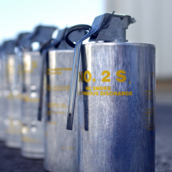 Close up photograph of a row of metal tear gas cannisters