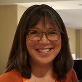 Photo of Martha Matsuoka from the shoulders up, smiling at the camera.